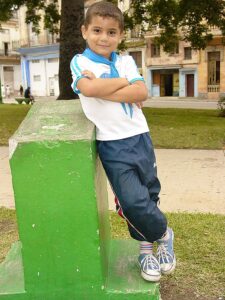 Young boy in confident pose, Centro Habana, Havana. December 2006.. Photo by Adam Jones Adam63, CC BY-SA 3.0 <https://creativecommons.org/licenses/by-sa/3.0>, via Wikimedia Commons
