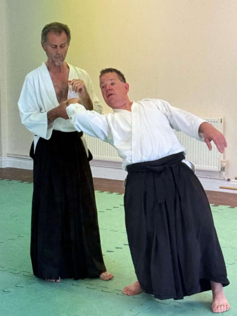 Piers Cooke (7th Dan) putting Aikido hold onto Dan Easton at the ADL annual seminar June 2025